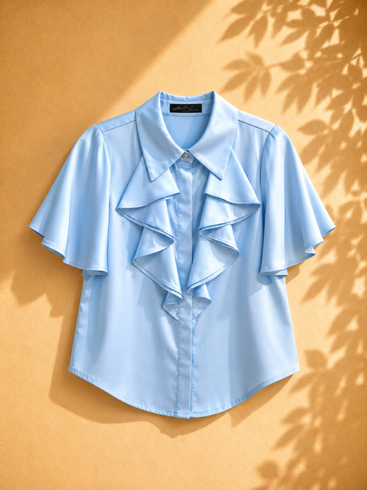 CAMISA SATINADA AZUL DE REVUELO EN LA RPARTE DE ALFRENTE